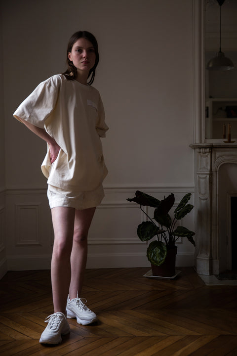 Dalva is wearing White Canvas sustainable natural cotton jersey oversized, genderless, seasonless t-shirt, one size. The natural cotton jersey t-shirt has minimal modern aesthetics design allowing comfort and bringing self-confidence. This unique piece is made locally in Paris to reduce environmental impact and guarantee high quality and durability of the products. 